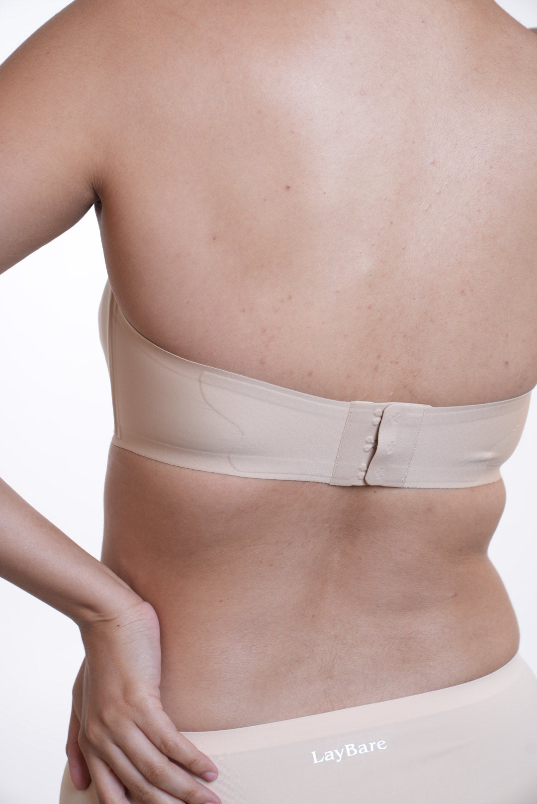 LayBareShop SnugHug strapless bra: seam-free, wireless support with natural lift and all day comfort. Perfect fit for off-shoulder looks and confident, carefree movement.